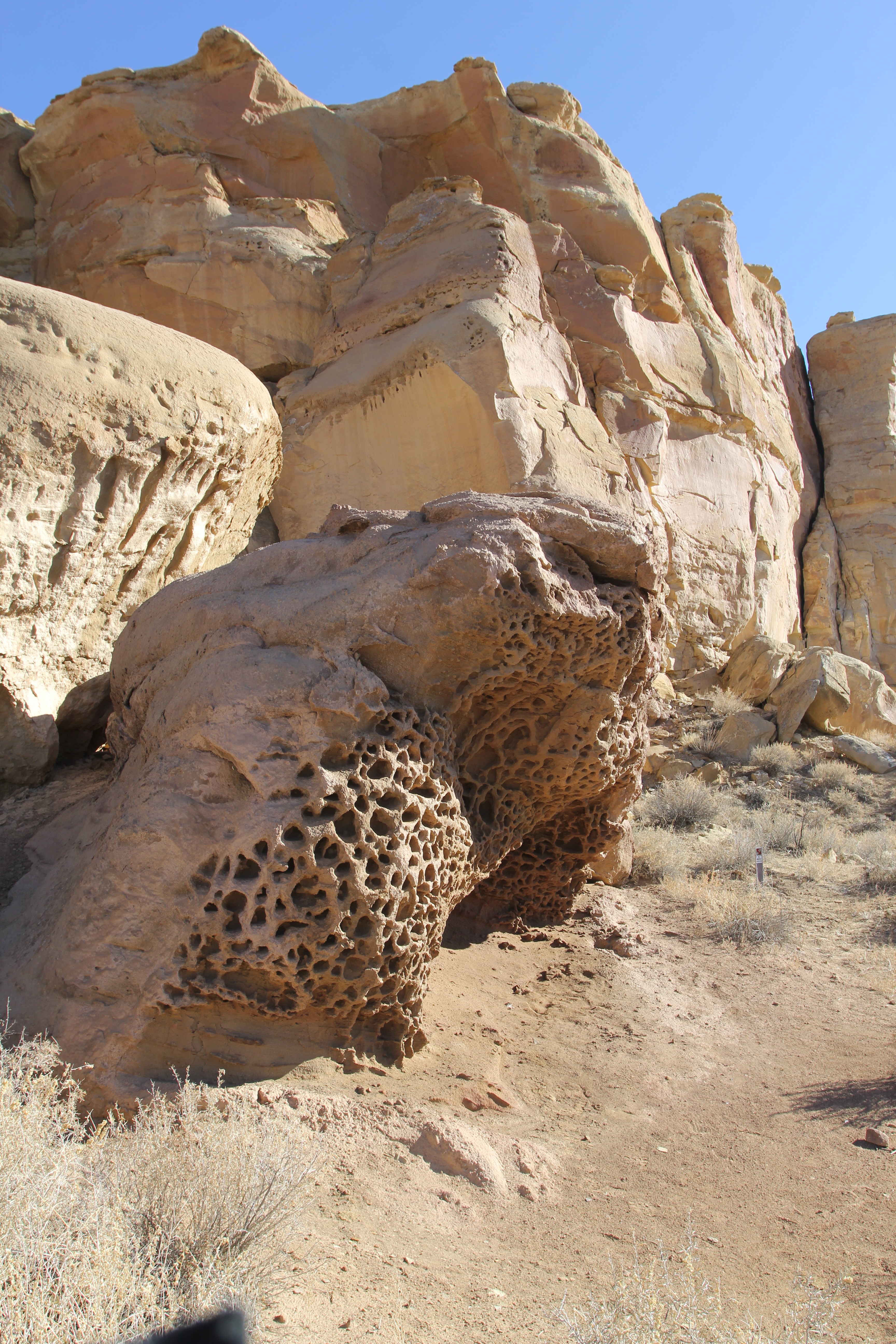 Weathered designs in the sandstone canyon walls from millions of years of erosion in Chaco Canyon